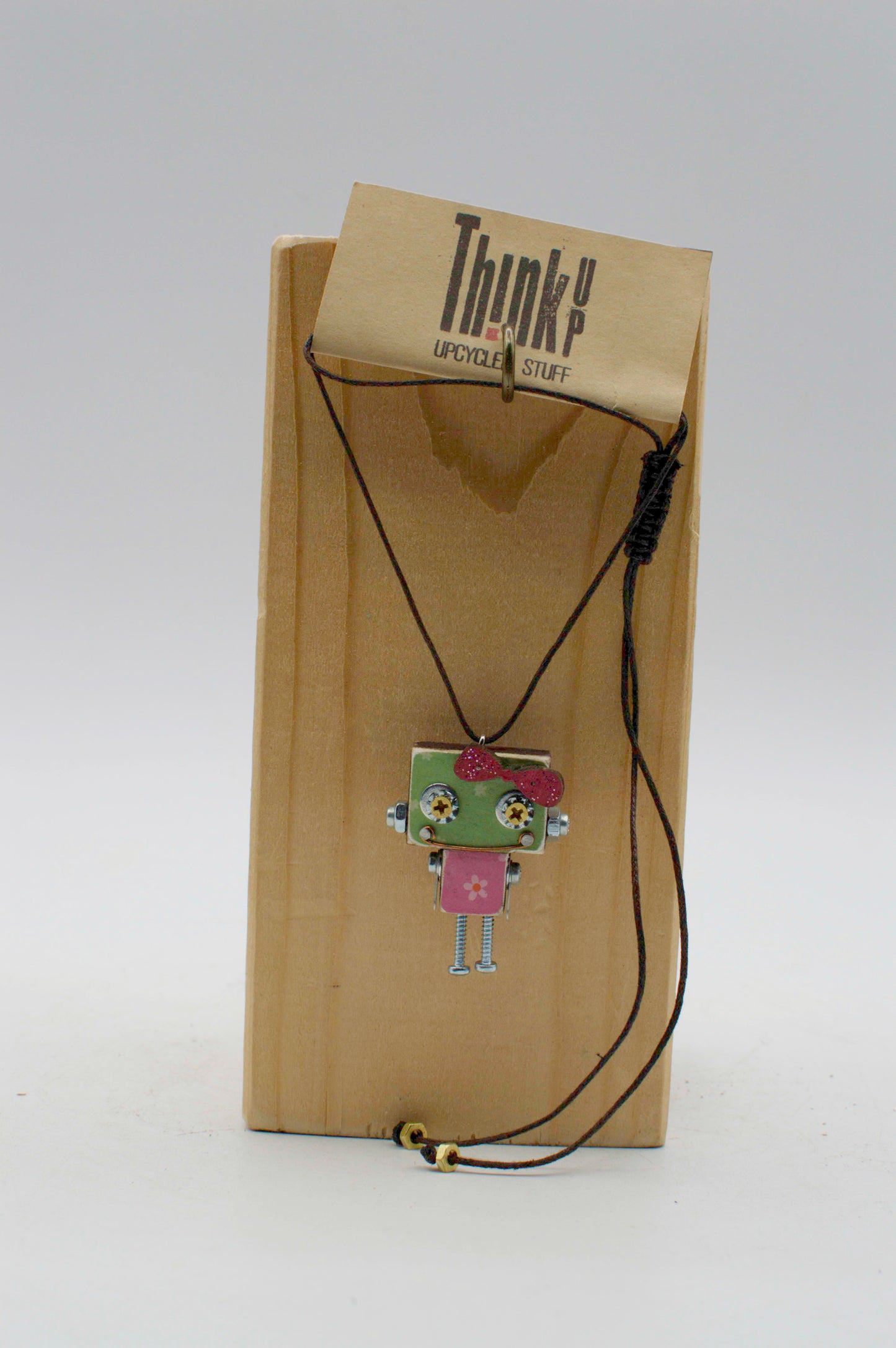 Ciondolino robot in legno tagliato a laser verde e rosa con dettagli argento su etichetta think & upcycled stuff
