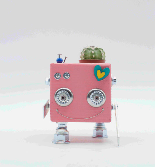 Vaso a forma di robot quadrato rosa con occhi metallici argento faccia sorridente e adesivo a forma di cuore in legno fatto a mano